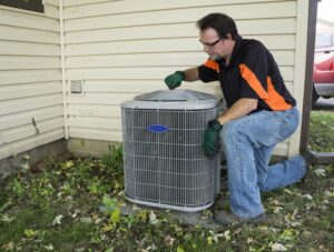 Man performing spring cleaning on St. George HVAC