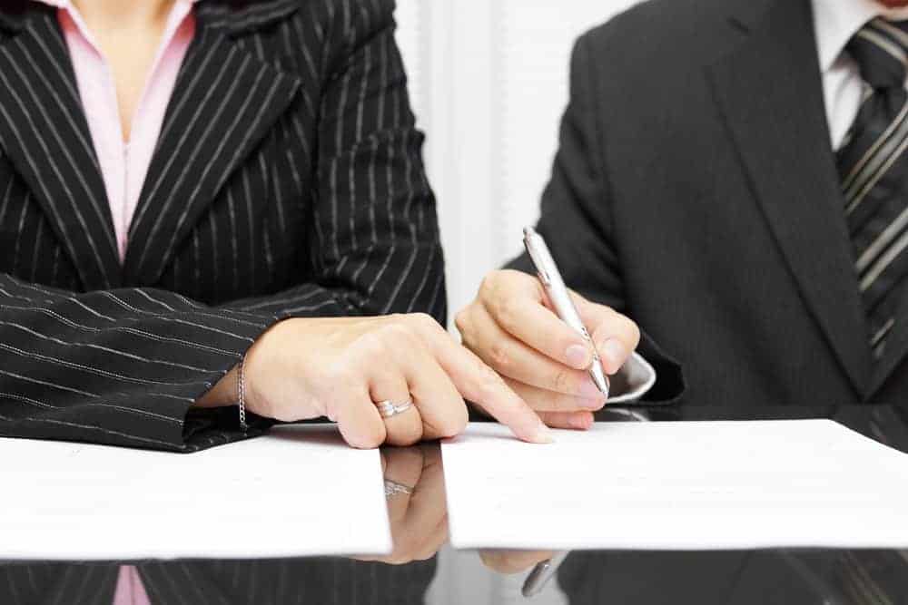 Business Lawyer Reviewing Paperwork With Client