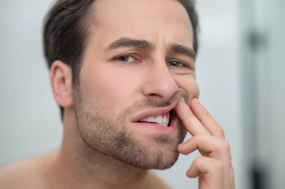 Man experiencing tooth pain