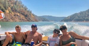 happy family on boat on the lake