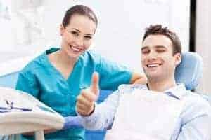 happy dental patient with dental hygienist